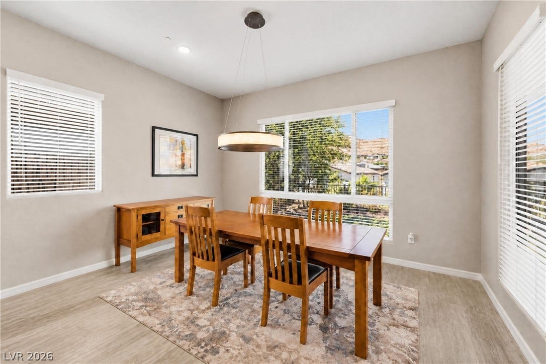 51 Thorn Creek Street, Henderson, NV 89011 Natural light streams through multiple windows onto the wood flooring of this dining space.