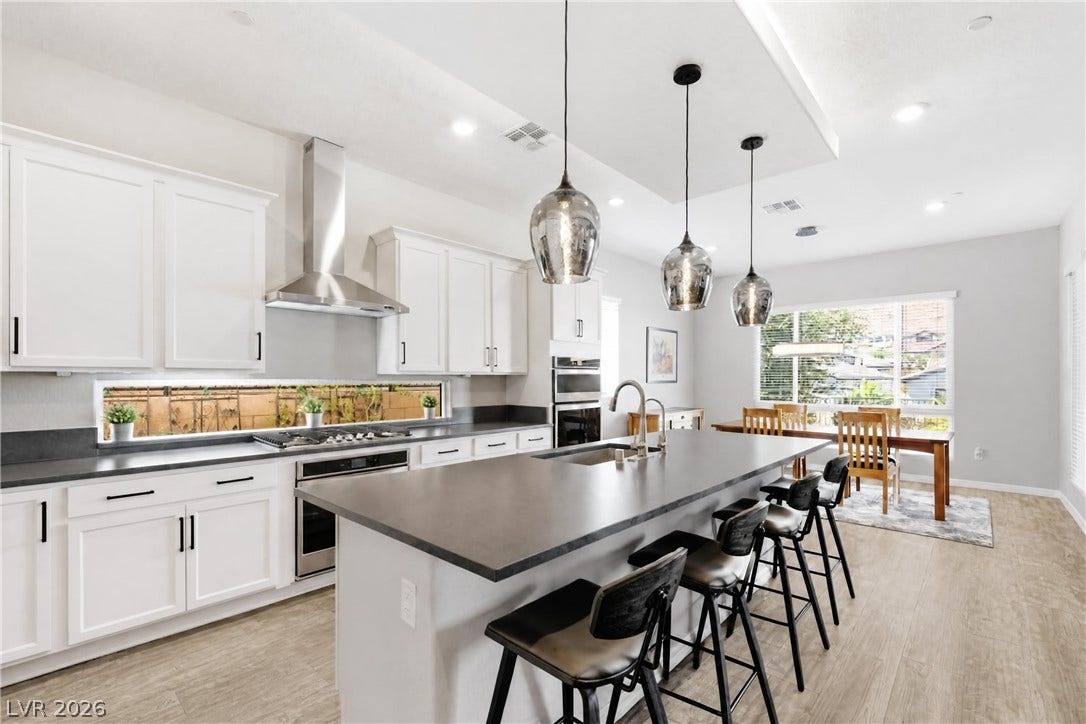 51 Thorn Creek Street, Henderson, NV 89011 Gleaming wood floors pair beautifully with crisp cabinetry and an expansive central island.