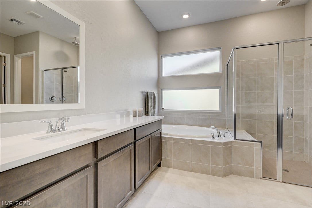 51 Thorn Creek Street, Henderson, NV 89011 Bathroom with vanity, a shower stall, a bath, light tile patterned floors, and recessed lighting