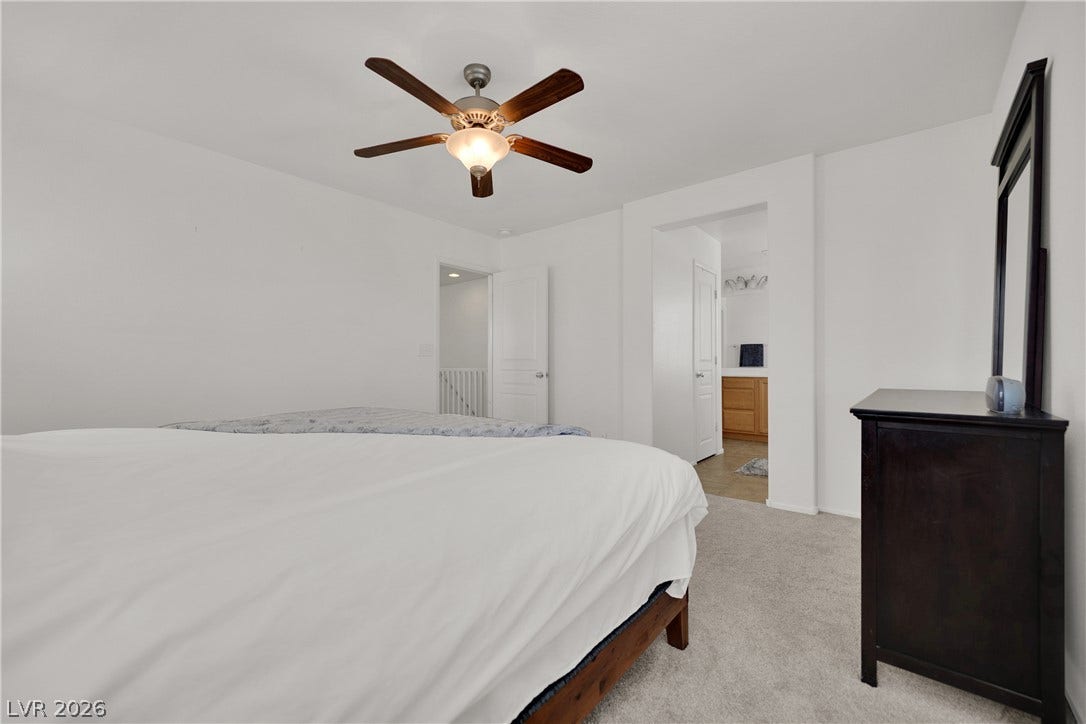 Soft carpeting underfoot defines this comfortable bedroom retreat opening directly to the master bath.