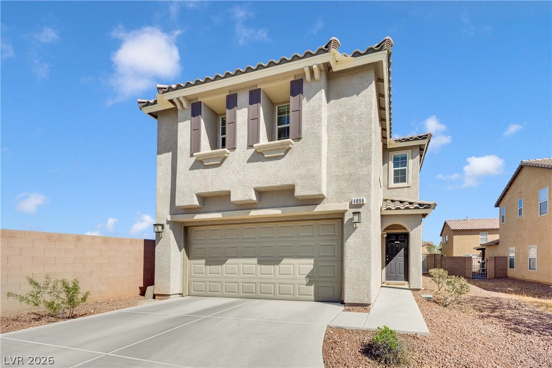 Spanish tile roofing and classic stucco detailing highlight this multi-level home design.