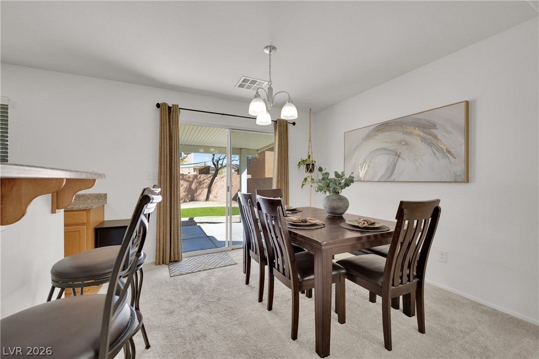 Glass sliding doors open from this carpeted dining area directly to the rear patio.