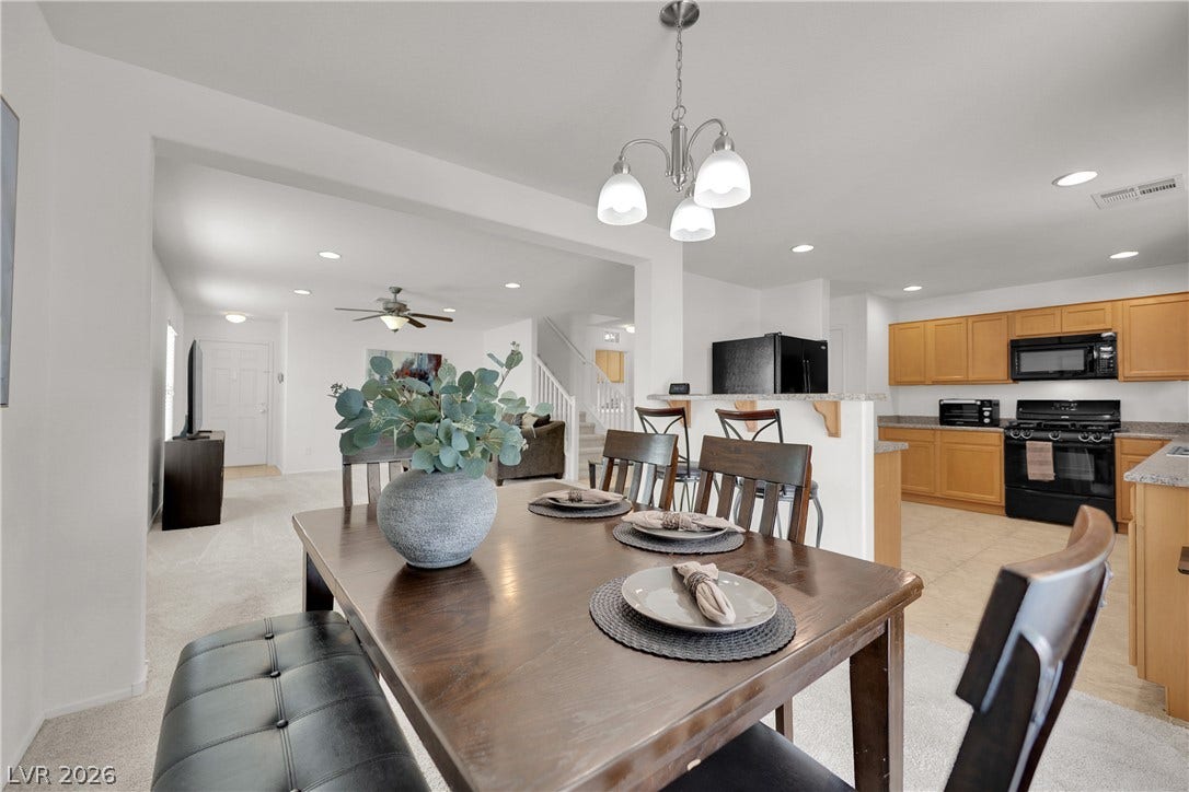An open floorplan seamlessly connects the dining space with the kitchen and living areas.