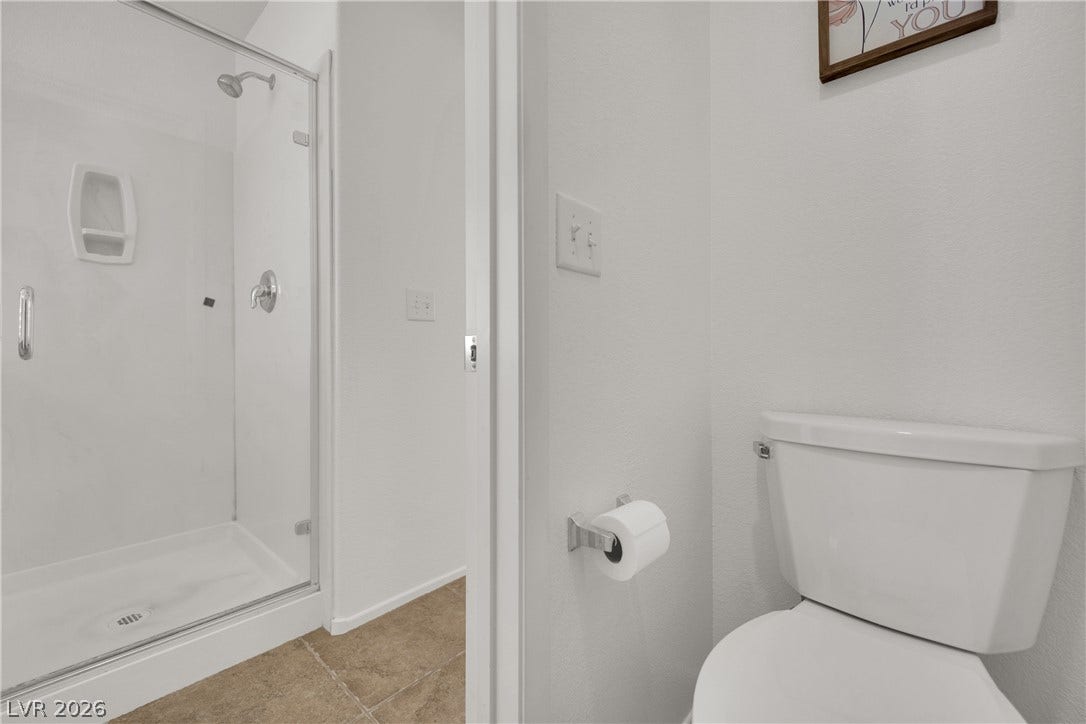 Clean lines and neutral tile flooring define this modern bathroom space.