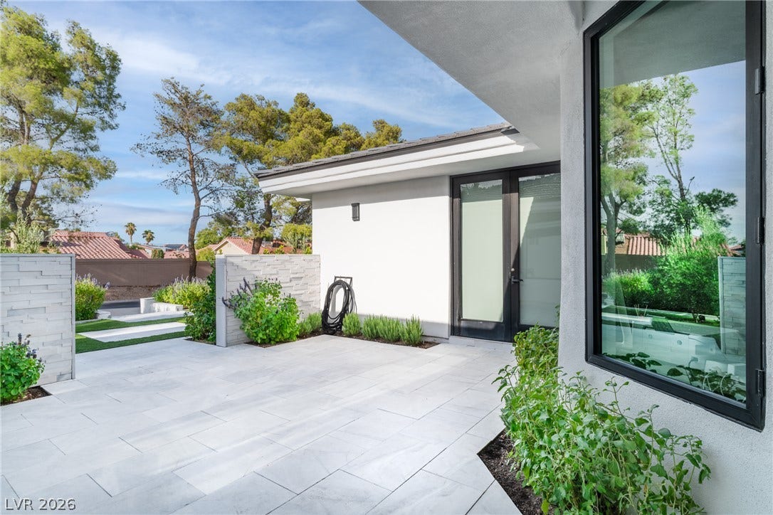 8633 Robinson Ridge Drive, Las Vegas, NV 89117 Sleek modern tiling and clean stucco walls define this elegant outdoor living area.