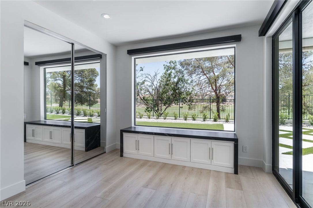8633 Robinson Ridge Drive, Las Vegas, NV 89117 A spacious picture window frames leafy garden views above integrated low-profile bench cabinetry.