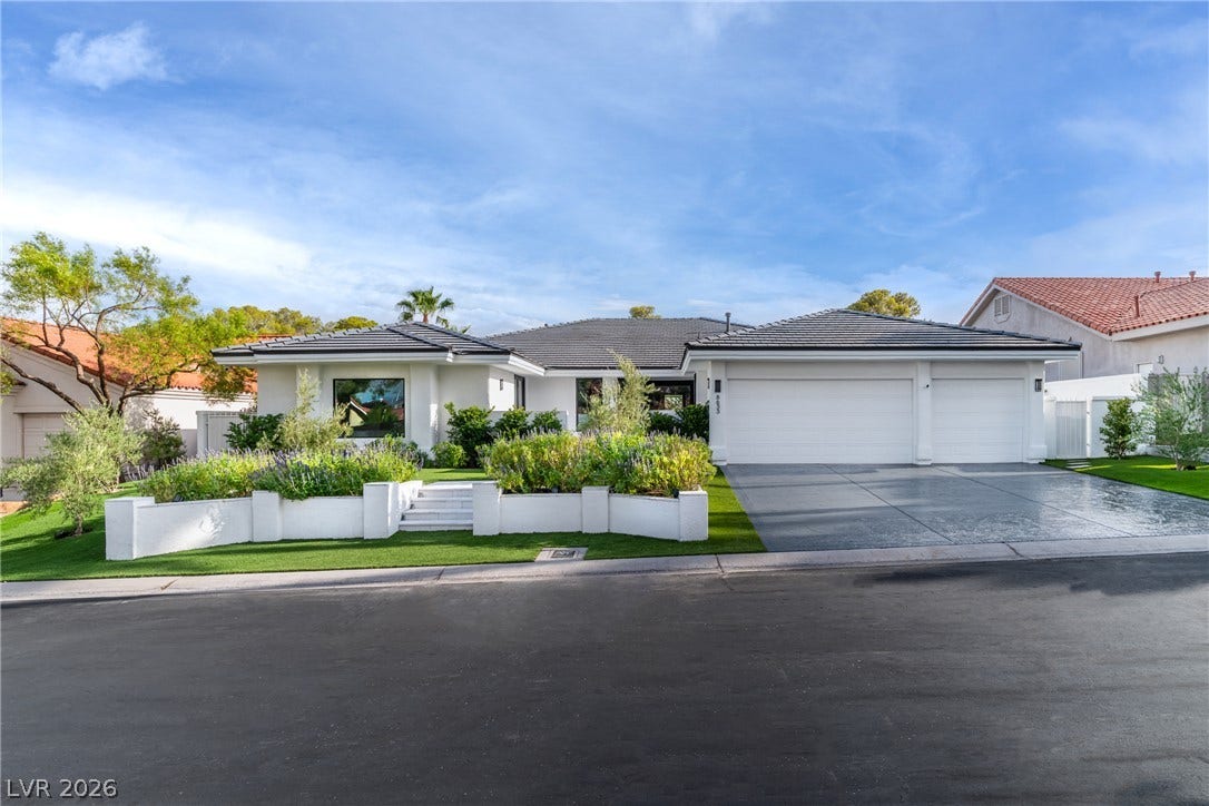 8633 Robinson Ridge Drive, Las Vegas, NV 89117 Manicured landscaping and a pristine driveway lead to a modern single-level residence.