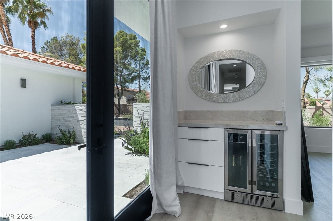 8633 Robinson Ridge Drive, Las Vegas, NV 89117 Floor-to-ceiling glass doors open to a sun-drenched patio and seamlessly connect indoor and outdoor spaces.