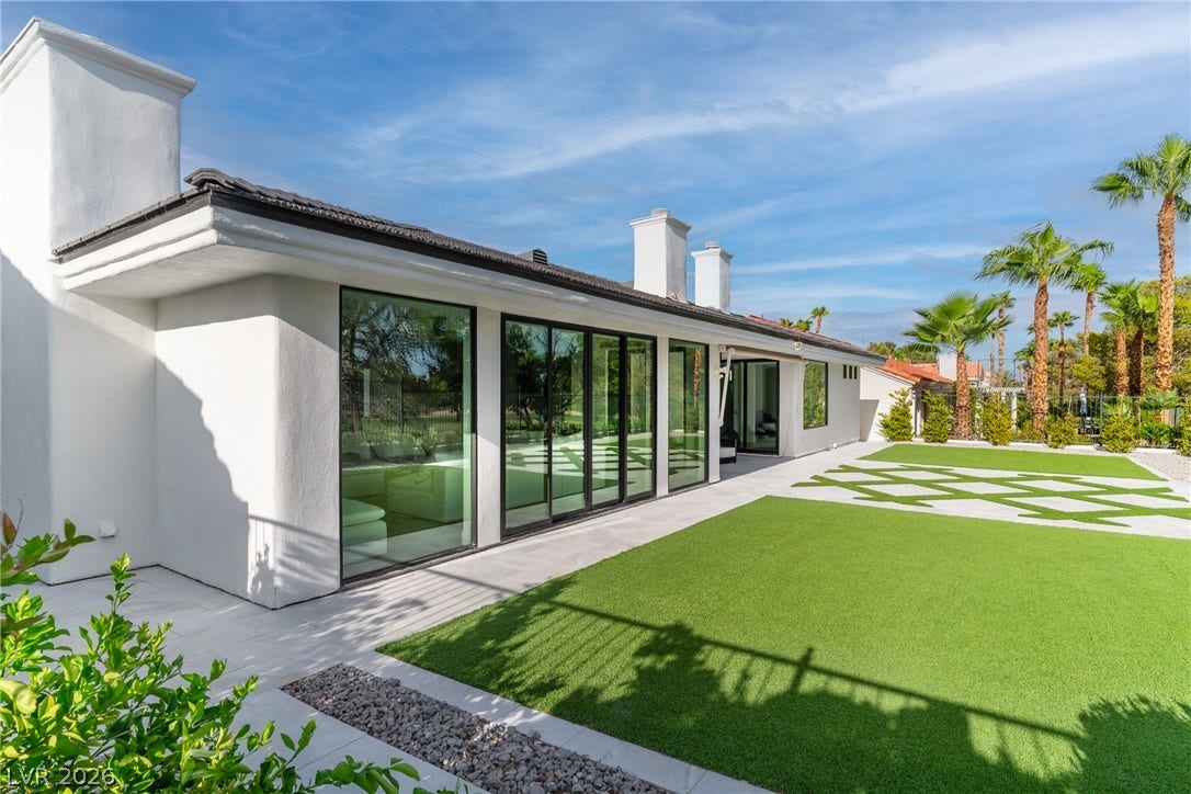 8633 Robinson Ridge Drive, Las Vegas, NV 89117 Smooth stucco walls and soaring glass panels define this striking contemporary rear exterior.