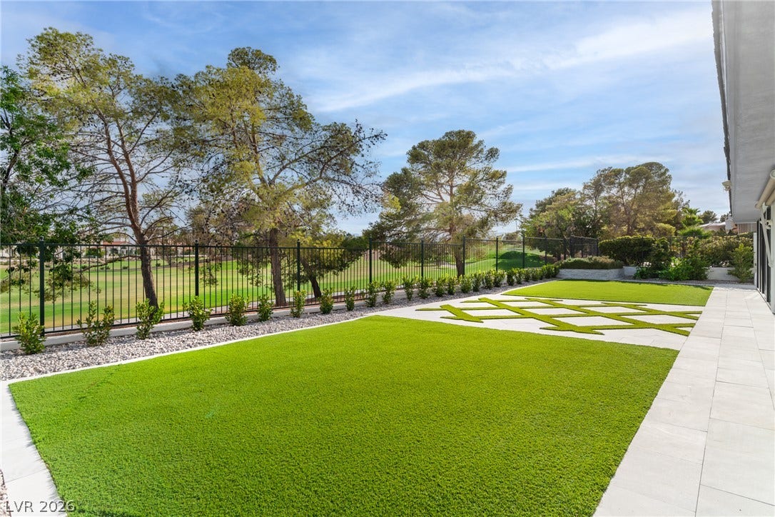 8633 Robinson Ridge Drive, Las Vegas, NV 89117 Manicured lawns and geometric hardscaping border a scenic golf course backdrop.