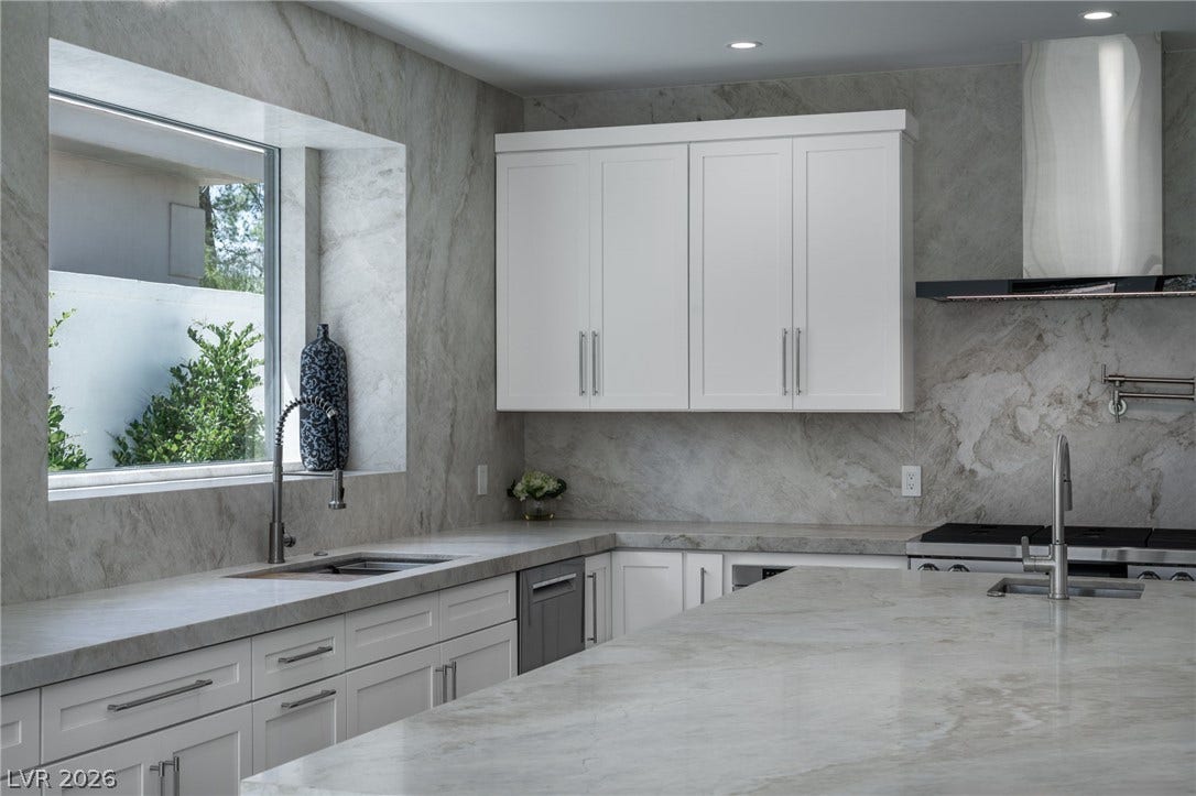 8633 Robinson Ridge Drive, Las Vegas, NV 89117 Gleaming stone surfaces and custom cabinetry define this high-end culinary space.