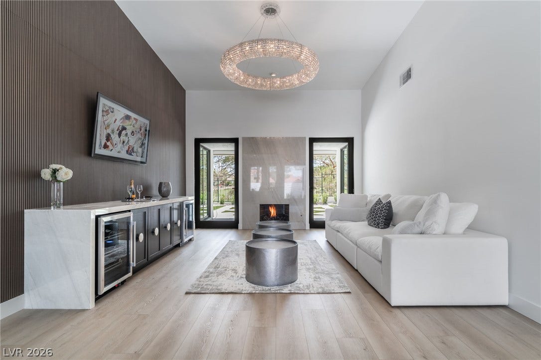 8633 Robinson Ridge Drive, Las Vegas, NV 89117 Gleaming light wood flooring and a modern fireplace create an inviting, stylish atmosphere.