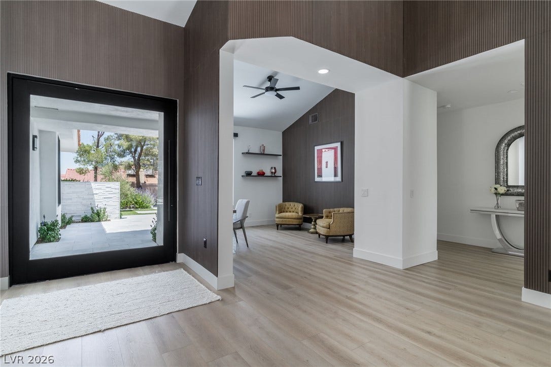 8633 Robinson Ridge Drive, Las Vegas, NV 89117 Dramatic wood-paneled walls and clean-lined wood flooring define this striking entry space.