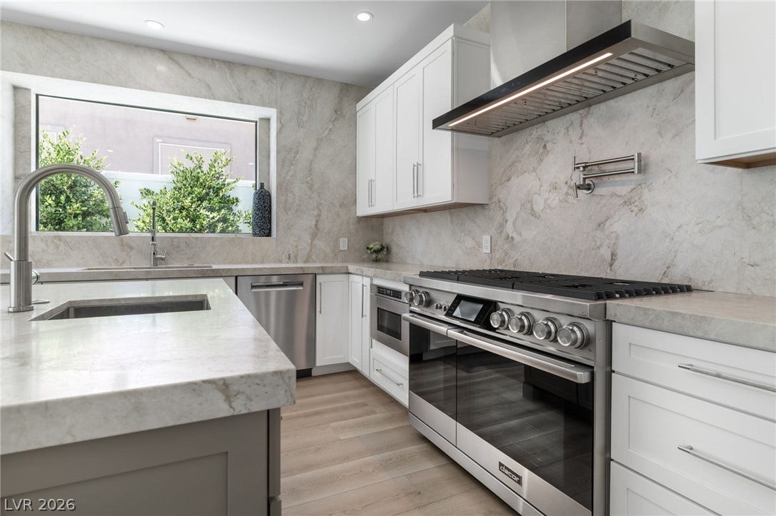 8633 Robinson Ridge Drive, Las Vegas, NV 89117 Elegant stone countertops and built-in professional appliances anchor this bright culinary space.