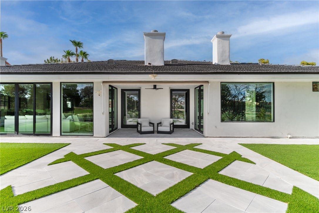 8633 Robinson Ridge Drive, Las Vegas, NV 89117 Geometrically patterned pavers integrate with manicured turf, leading to a sheltered patio alcove.