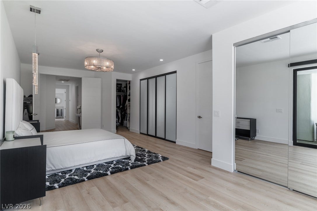 8633 Robinson Ridge Drive, Las Vegas, NV 89117 Recessed lighting and wide plank wood flooring define this generous bedroom suite.