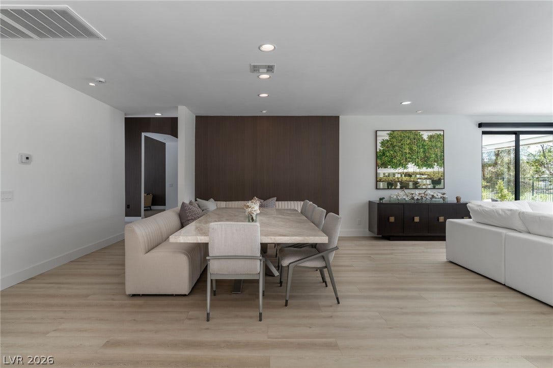 8633 Robinson Ridge Drive, Las Vegas, NV 89117 An open floor plan seamlessly connects the formal dining area with light hardwood floors.