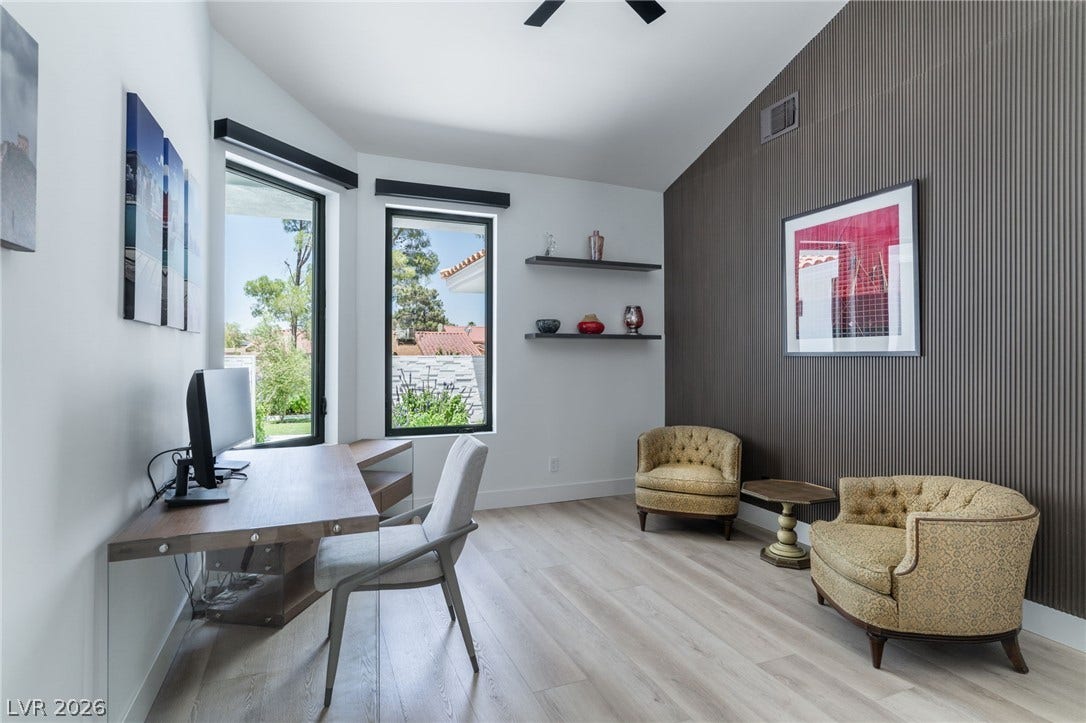 8633 Robinson Ridge Drive, Las Vegas, NV 89117 High ceilings and tall windows frame views of the outdoors in this modern workspace.