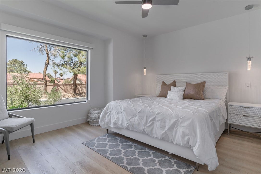 8633 Robinson Ridge Drive, Las Vegas, NV 89117 Clean lines and a picture window frame peaceful outdoor views in this modern bedroom.