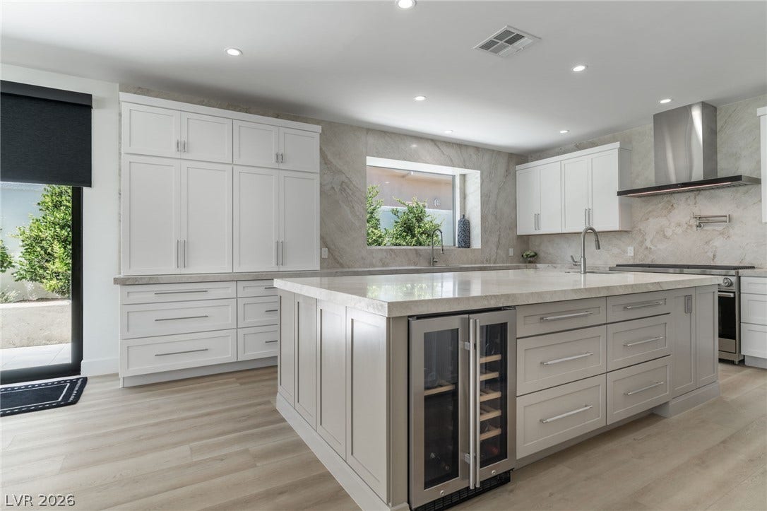 8633 Robinson Ridge Drive, Las Vegas, NV 89117 An expansive kitchen island with stone counters anchors this modern culinary space.