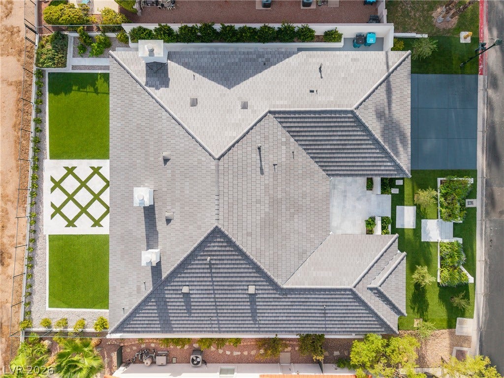 8633 Robinson Ridge Drive, Las Vegas, NV 89117 A pristine tiled roof crowns this modern residence bordered by manicured geometric landscaping.