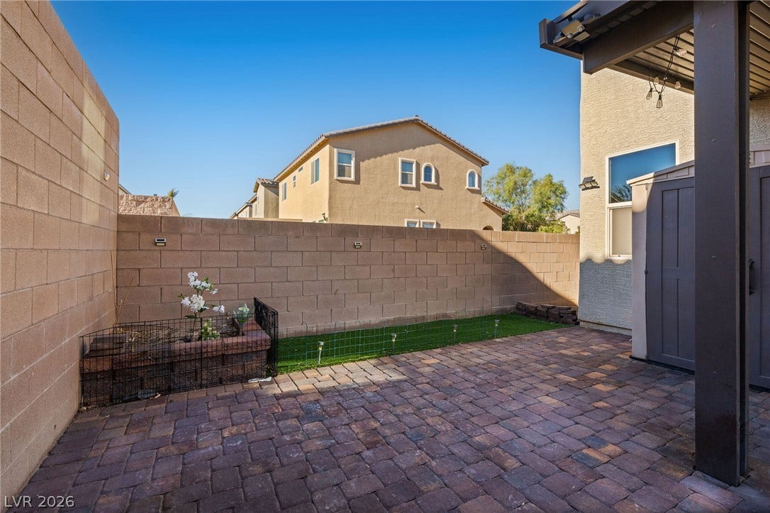 4605 Fragrant Street, North Las Vegas, NV 89031 An inviting paved patio sits enclosed by secure block walls under clear blue skies.