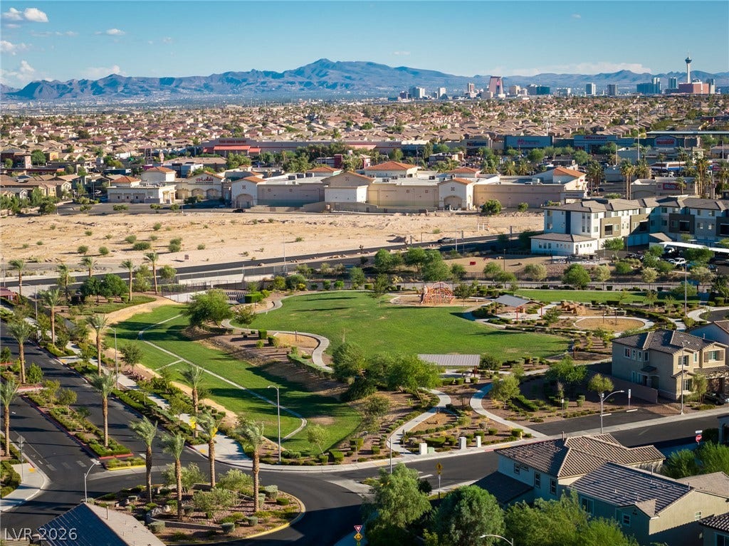 4605 Fragrant Street, North Las Vegas, NV 89031 Distant mountains frame a panoramic neighborhood view overlooking a central green park with winding pathways.