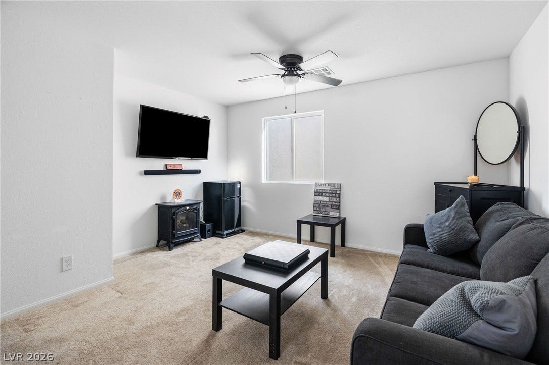 4605 Fragrant Street, North Las Vegas, NV 89031 Soft wall-to-wall carpeting and clean plaster walls anchor this comfortable secondary living space.
