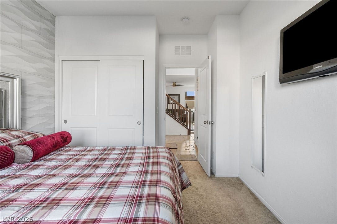 4605 Fragrant Street, North Las Vegas, NV 89031 Downstairs bedroom, plush carpeting underfoot complements the crisp architectural lines of this cozy bedroom retreat.