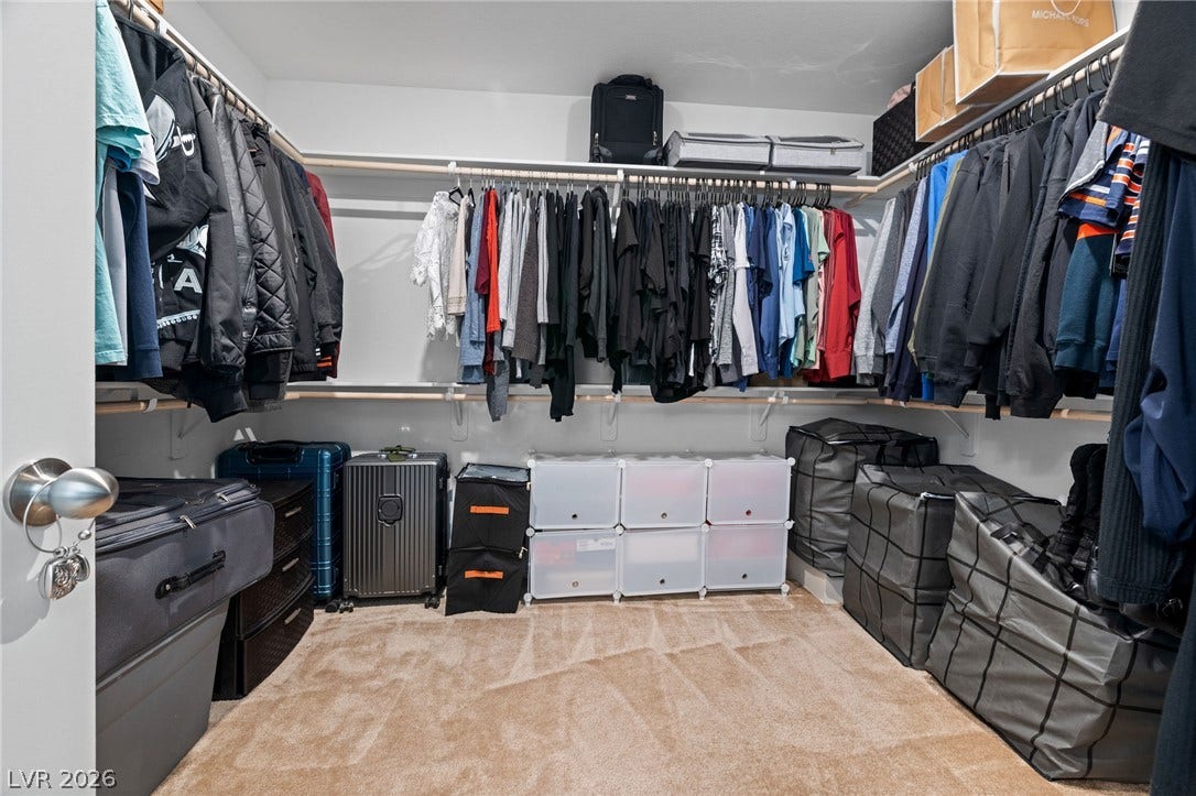 4605 Fragrant Street, North Las Vegas, NV 89031 Masters Walk-In-Closet, ample hanging rods and overhead shelving maximize organization within this spacious carpeted walk-in closet.