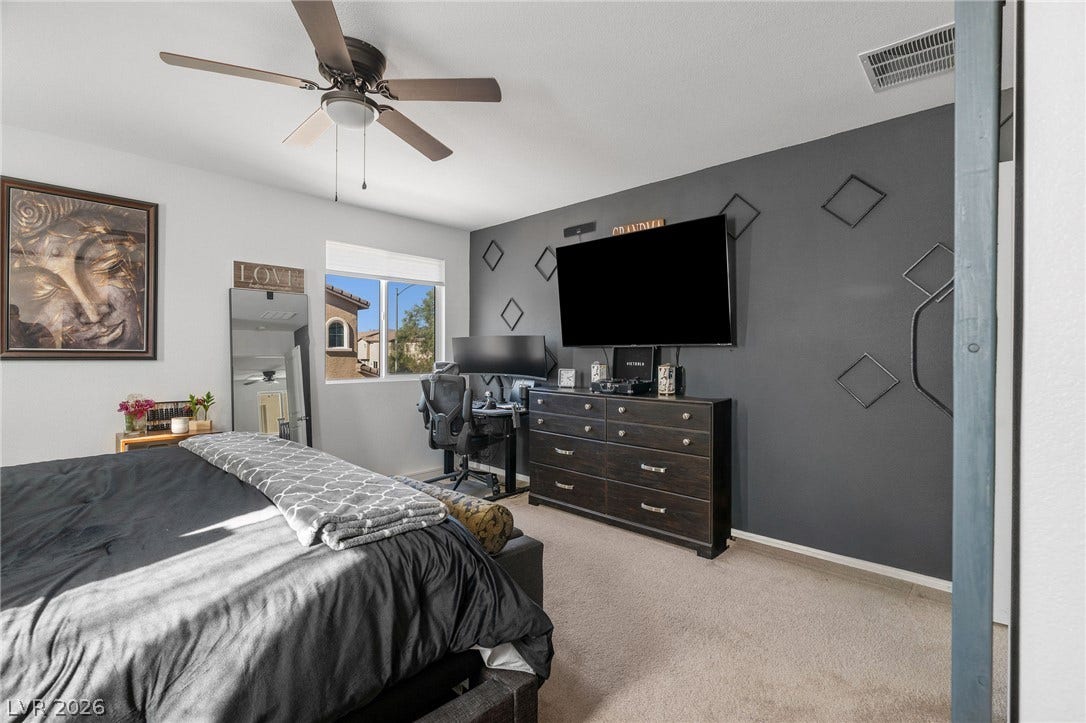 4605 Fragrant Street, North Las Vegas, NV 89031 Plush carpeting and a large window define this comfortable bedroom space.