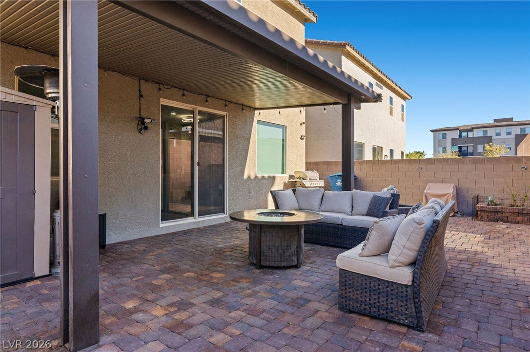 4605 Fragrant Street, North Las Vegas, NV 89031 An inviting covered patio features extensive brick paver flooring and adjacent sliding glass doors.