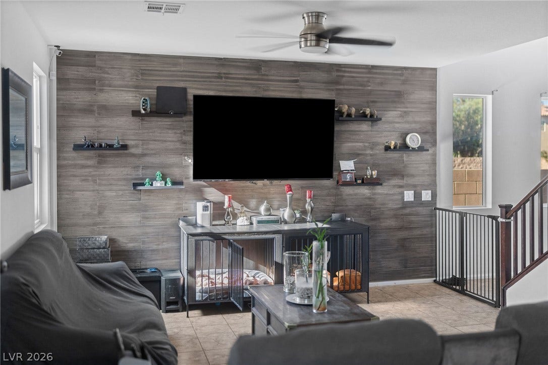 4605 Fragrant Street, North Las Vegas, NV 89031 An accent wall anchors the open living space featuring tile floors and recessed lighting.