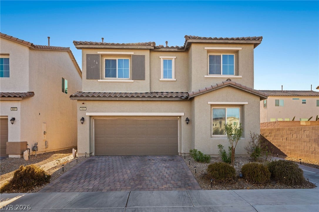 4605 Fragrant Street, North Las Vegas, NV 89031 An inviting two-story stucco exterior features a paved driveway leading to a two-car garage.