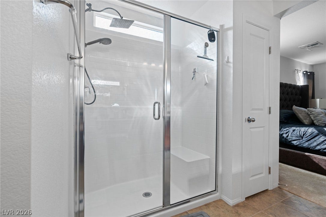4605 Fragrant Street, North Las Vegas, NV 89031 A contemporary walk-in shower features classic subway tile and a built-in bench seat.
