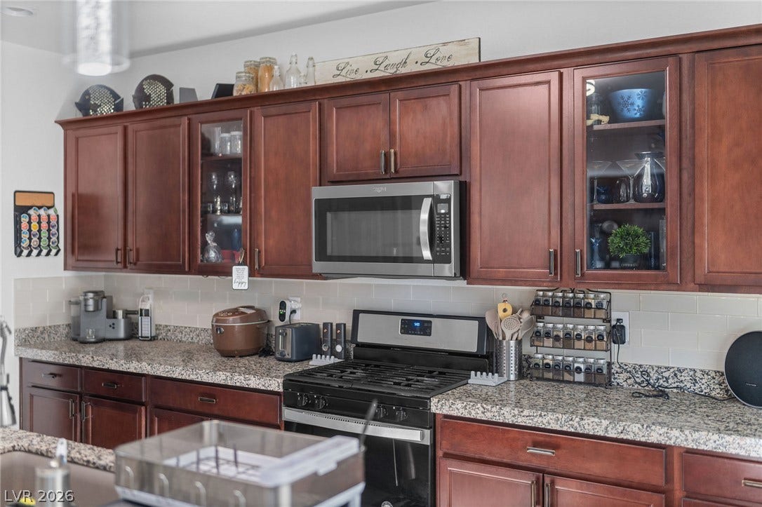 4605 Fragrant Street, North Las Vegas, NV 89031 Rich wood cabinetry pairs beautifully with granite countertops in this functional workspace.