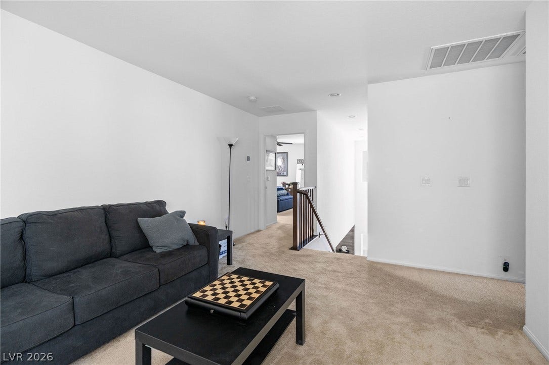 4605 Fragrant Street, North Las Vegas, NV 89031 Soft carpeting covers the floor of this upper-level common area positioned near the stairs.