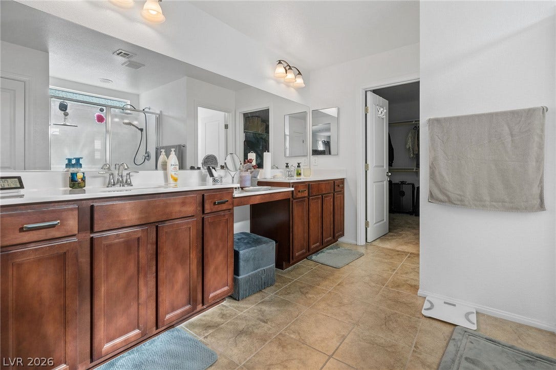 4605 Fragrant Street, North Las Vegas, NV 89031 Master bedroom BA, a spacious vanity with dual sinks anchors this well-appointed bathroom alongside warm tile flooring.
