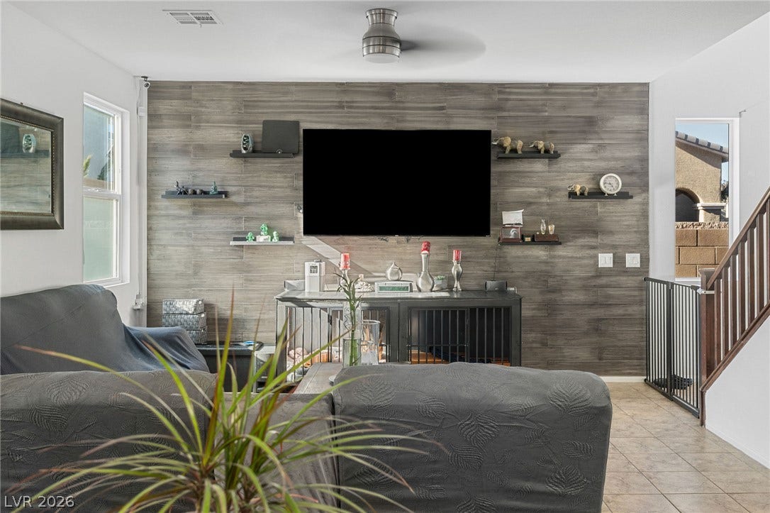 4605 Fragrant Street, North Las Vegas, NV 89031 A modern wood-plank accent wall and tile flooring anchor this inviting living space.