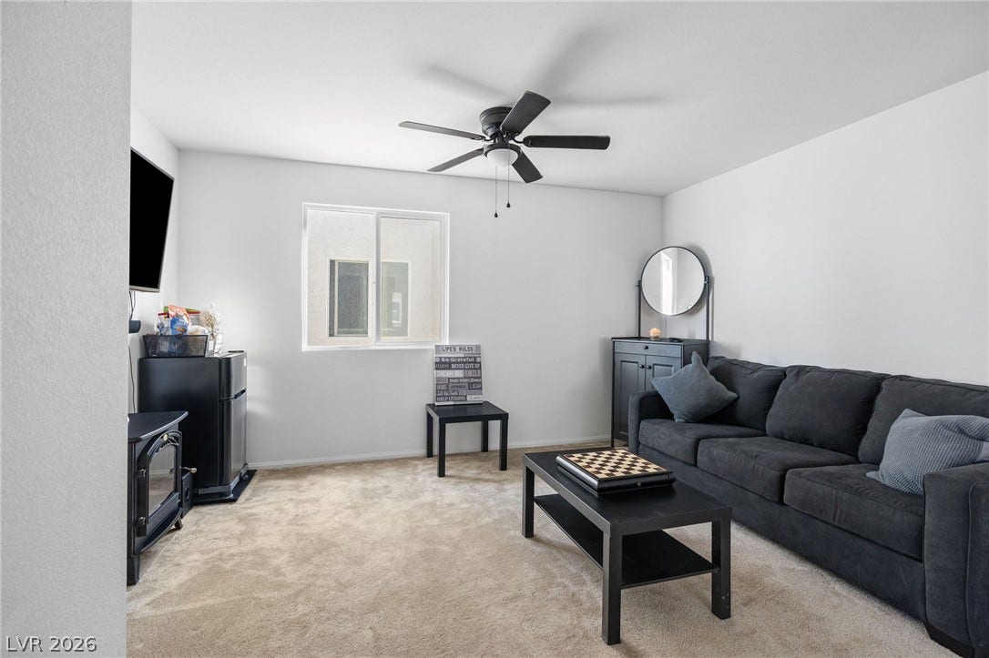 4605 Fragrant Street, North Las Vegas, NV 89031 Plush carpet flooring pairs with smooth walls under a clean white ceiling in this room.