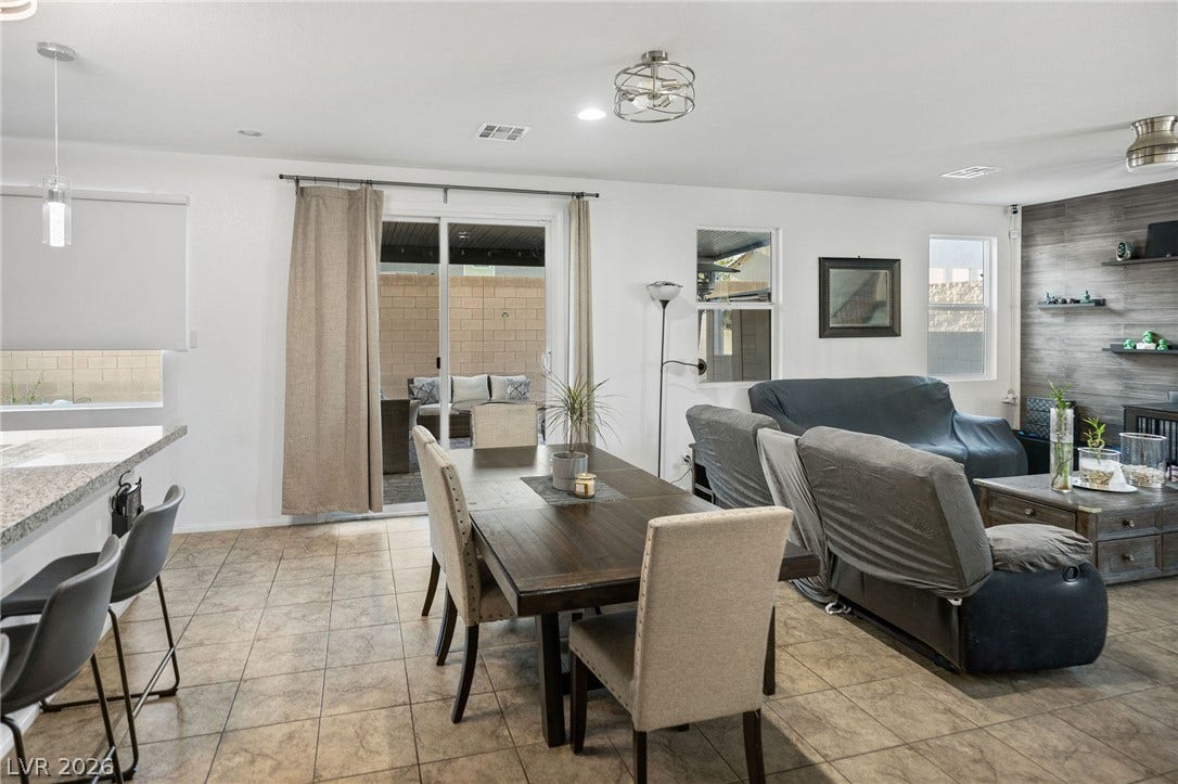 4605 Fragrant Street, North Las Vegas, NV 89031 An open floorplan seamlessly connects the dining space to the living area and outdoor patio.