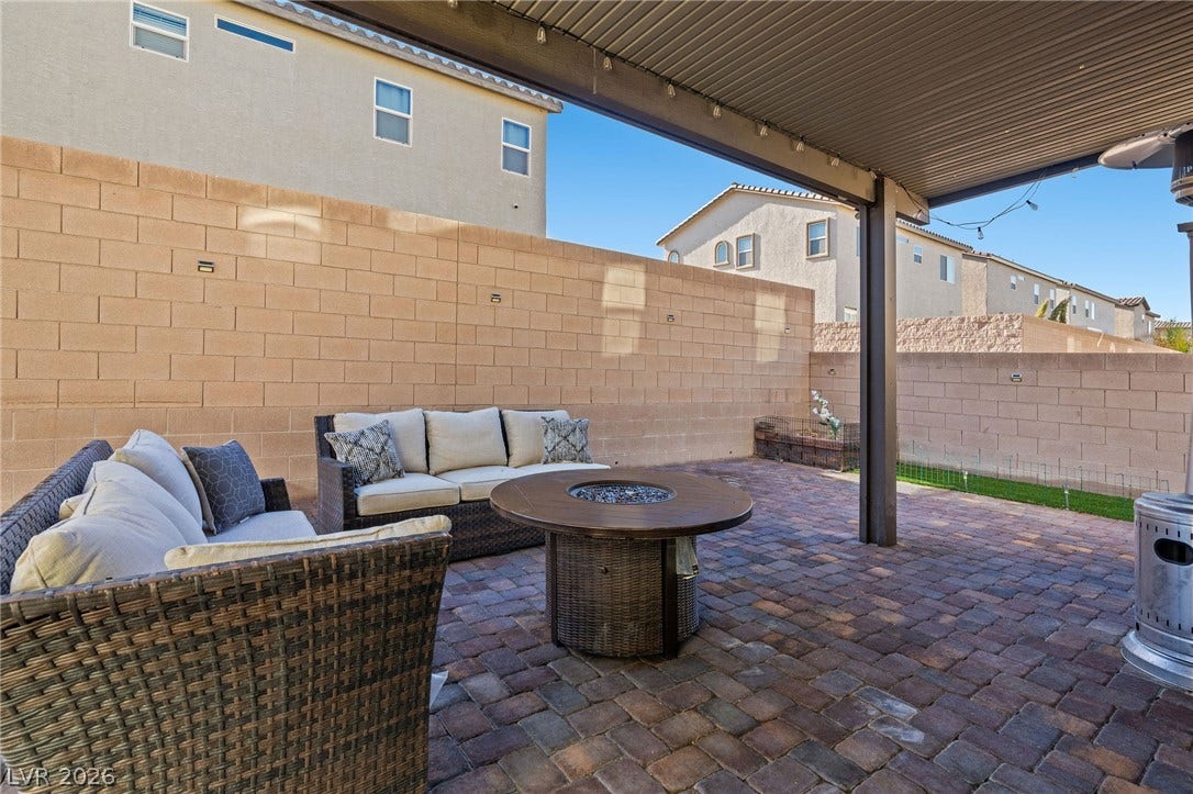4605 Fragrant Street, North Las Vegas, NV 89031 A spacious brick paver patio features a substantial shade structure and high block wall fencing.