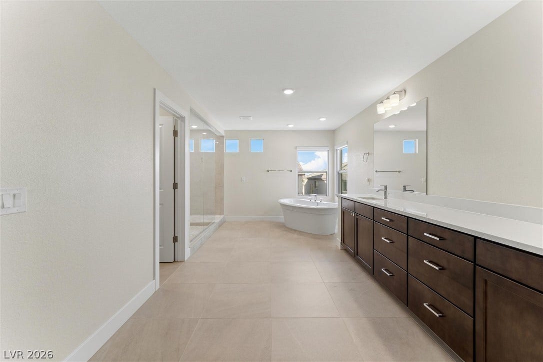 8724 Fortplaid Street, Las Vegas, NV 89139 Clean lines and stone-look tile flooring define this spacious master bath layout.