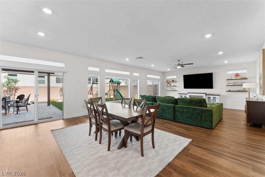 8724 Fortplaid Street, Las Vegas, NV 89139 Warm wood flooring and recessed lighting define this inviting open-concept living and dining layout.