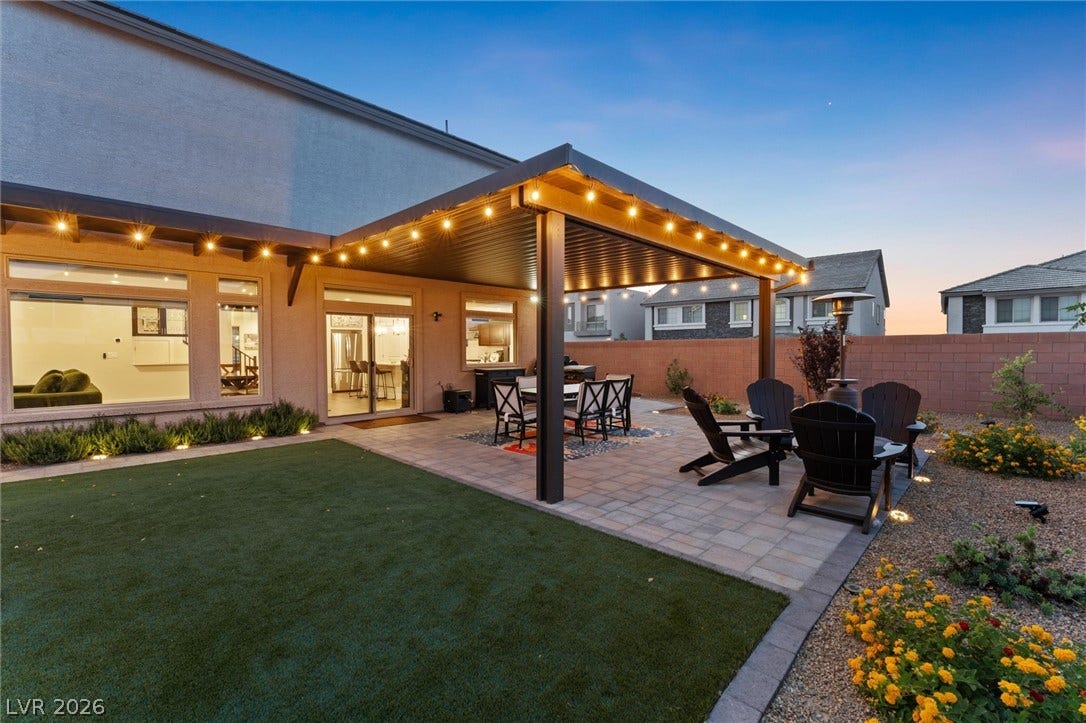 8724 Fortplaid Street, Las Vegas, NV 89139 A spacious backyard patio features integrated lighting underneath a modern shade structure.