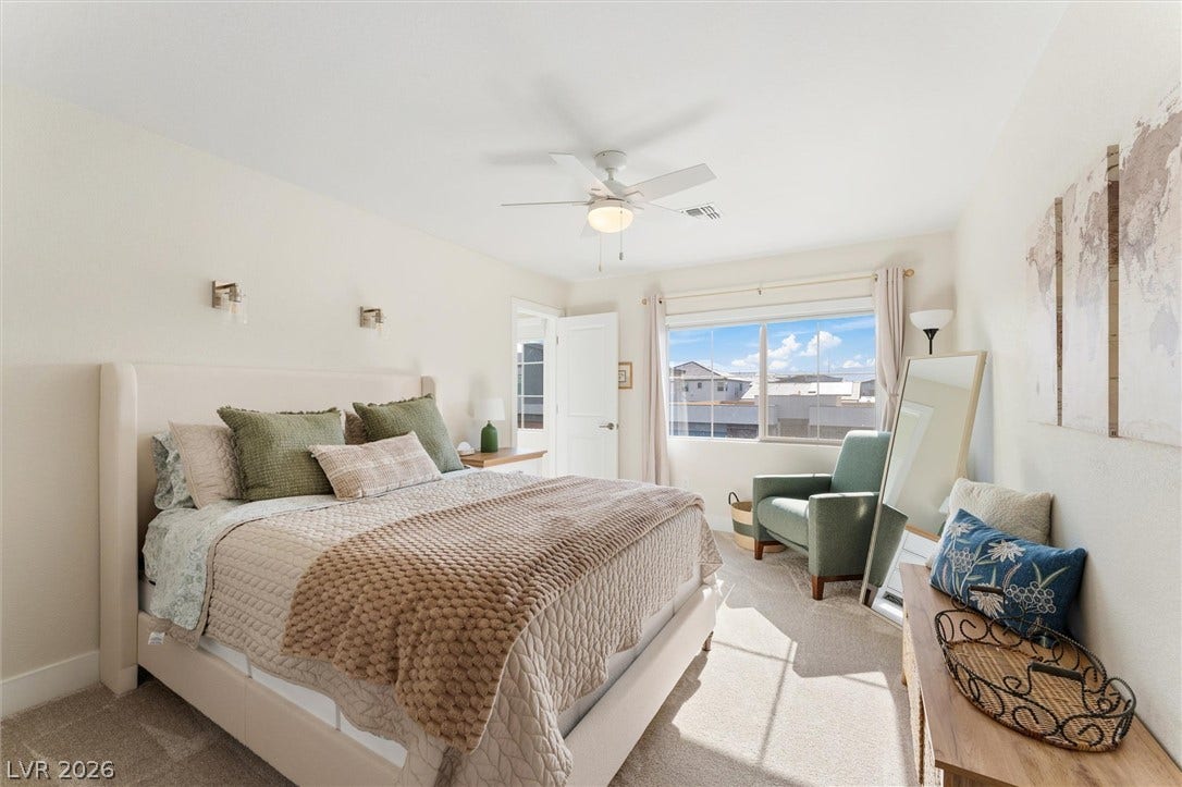 8724 Fortplaid Street, Las Vegas, NV 89139 Plentiful natural light streams through a wide window, illuminating smooth walls and soft carpet.