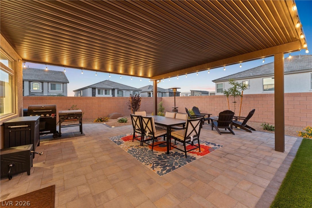 8724 Fortplaid Street, Las Vegas, NV 89139 An inviting covered patio features extensive stone pavers and structured shade for outdoor relaxation.