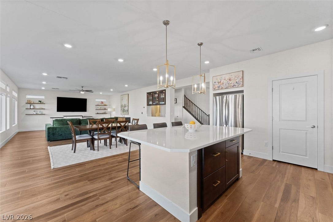 8724 Fortplaid Street, Las Vegas, NV 89139 An open main level integrates the kitchen and living areas over rich wood floors.