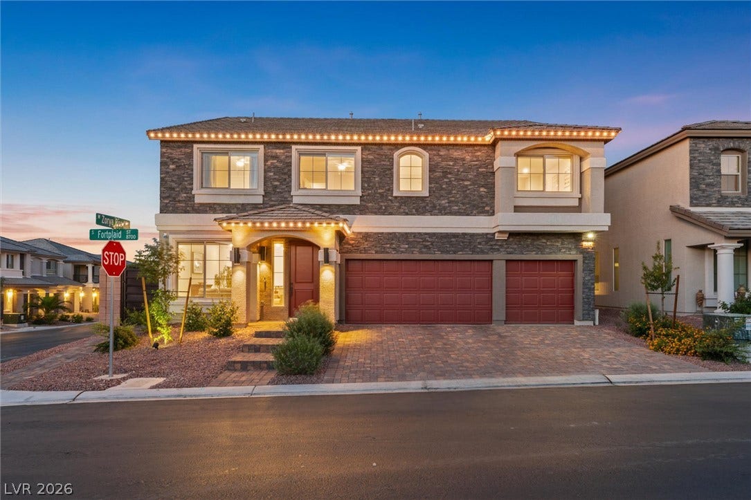 8724 Fortplaid Street, Las Vegas, NV 89139 A striking stone facade highlights the elegant front elevation of this multi-car garage home.