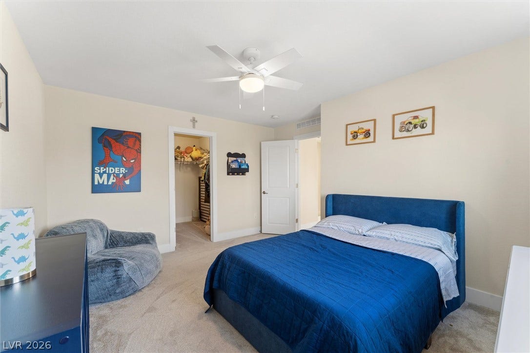 8724 Fortplaid Street, Las Vegas, NV 89139 A spacious secondary bedroom features plush neutral carpeting and a convenient walk-in closet.